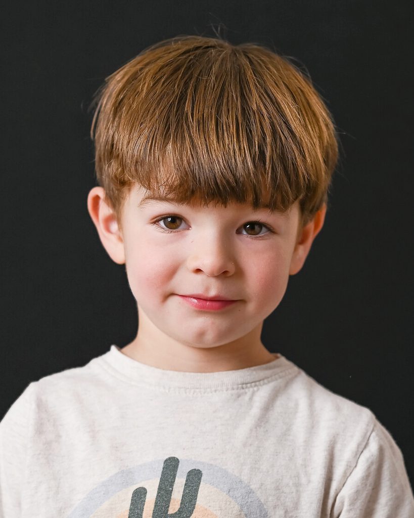 a boy smiling on the camera